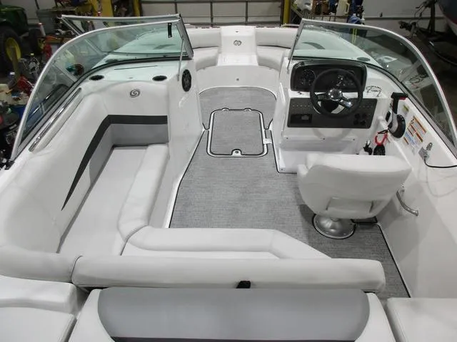 Slide: The Image of 2023 Hurricane SunDeck 187 IO boat interior with white seating and modern dashboard. - 4