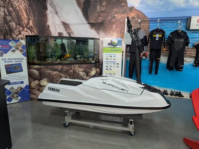 Slide: The Image of 2025 Yamaha WaveRunner SuperJet displayed in showroom with aquatic and diving gear. - 3