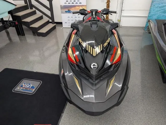 Slide: The Image of 2019 Sea-Doo RXP-X 300 Waverunner in black and lava red, showroom display. - 3