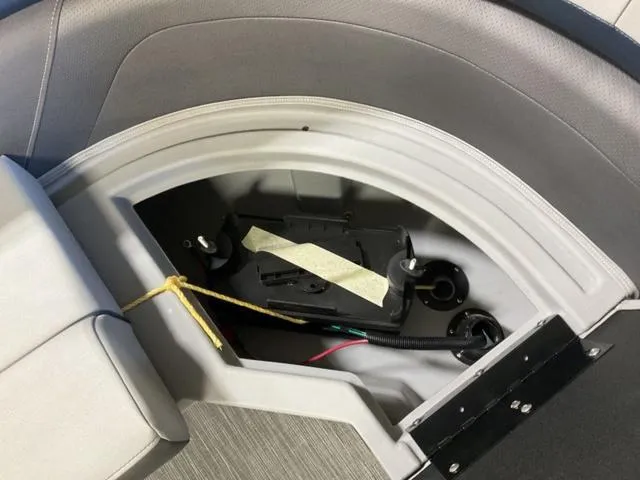 Slide: The Image of 2023 Bennington 23 SXSR boat storage compartment with battery and wiring. - 11