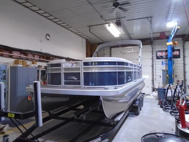 Slide: The Image of 2023 Bennington 23 SXSR pontoon boat in a garage on a trailer. - 15