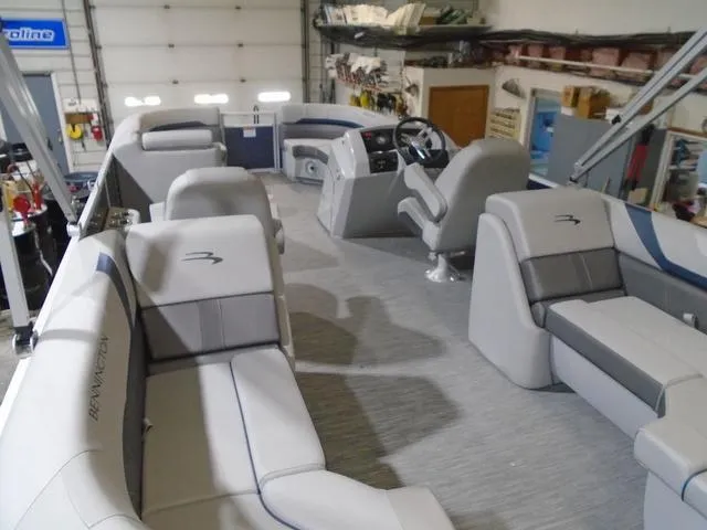 Slide: The Image of 2023 Bennington 23 SXSR pontoon boat interior with gray seating and steering console. - 16