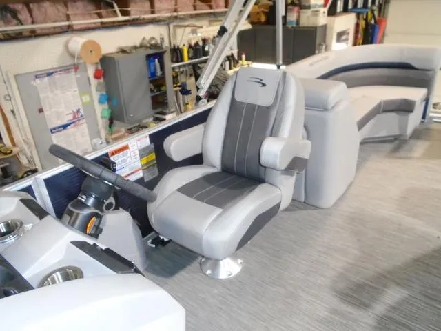 Slide: The Image of 2023 Bennington 23 SXSR boat interior with captain's chair and control panel. - 22