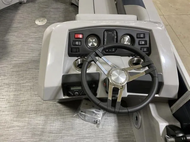 Slide: The Image of 2023 Bennington 23 SXSR boat dashboard with steering wheel and controls. - 3