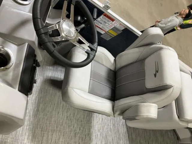 Slide: The Image of 2023 Bennington 23 SXSR boat interior with steering wheel and plush seating. - 8