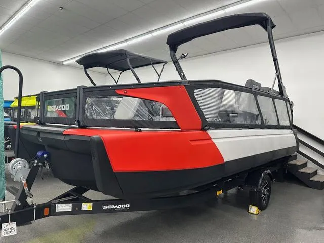 Slide: The Image of 2023 Sea-Doo Switch® Sport 21-230 hp boat on trailer, red and white design. - 1