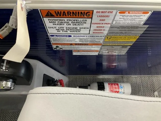 Slide: The Image of Safety warnings and instructions on a 2023 Bennington 23 LSB boat dashboard. - 13
