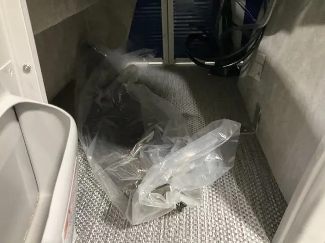 Slide: The Image of Interior of a 2023 Bennington 23 LSB boat with plastic covering on the floor. - 15