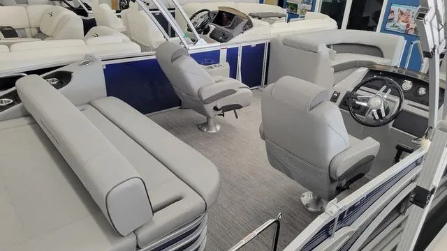Slide: The Image of 2023 Bennington 23 LSB pontoon boat interior with gray seating and modern dashboard. - 18