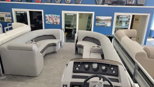Slide: The Image of Interior of 2023 Bennington 23 LSB pontoon boat with plush seating and control panel. - 3