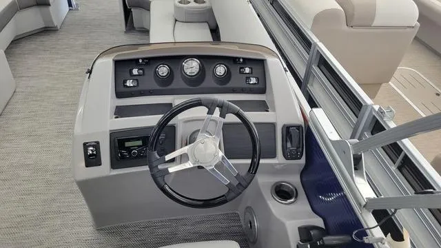 Slide: The Image of 2023 Bennington 23 LSB boat dashboard with steering wheel and control panel. - 4