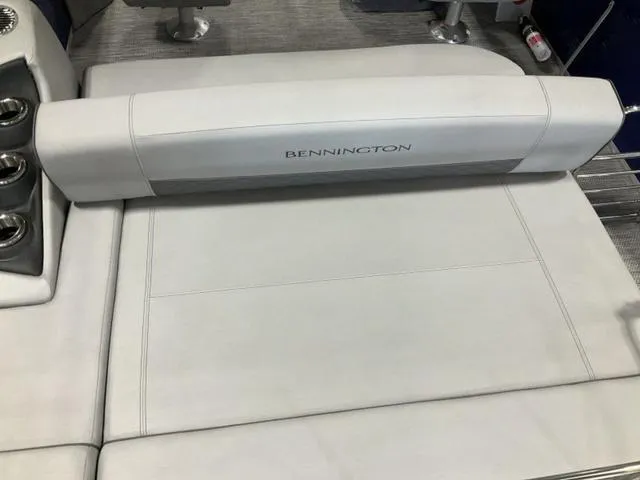 Slide: The Image of 2023 Bennington 23 LSB boat interior with white cushioned seating and cup holders. - 7