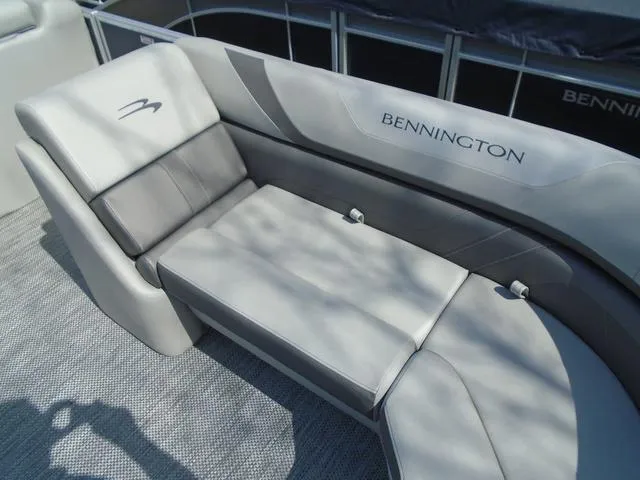 Slide: The Image of 2024 Bennington 21 SXL boat interior with luxurious gray seating and logo. - 10