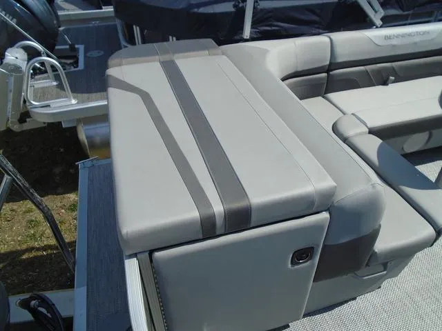 Slide: The Image of 2024 Bennington 21 SXL boat seating with sleek gray upholstery and modern design. - 14