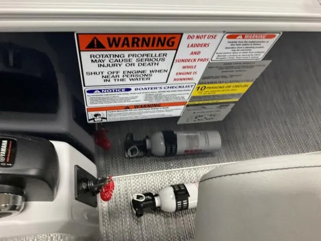 Slide: The Image of 2024 Bennington 21 SXL boat warning labels and safety equipment, including fire extinguisher. - 18