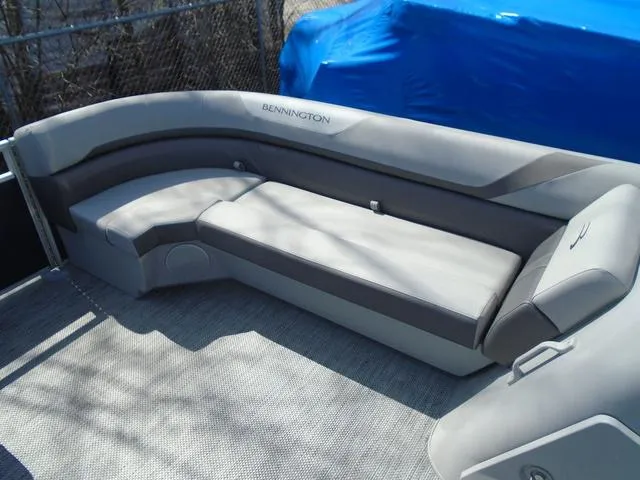 Slide: The Image of 2024 Bennington 21 SXL pontoon boat with spacious seating and modern design. - 23