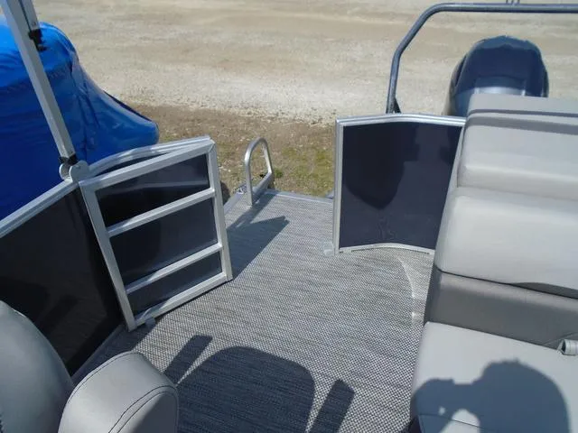 Slide: The Image of 2024 Bennington 21 SXL pontoon boat interior with open gate and seating. - 26