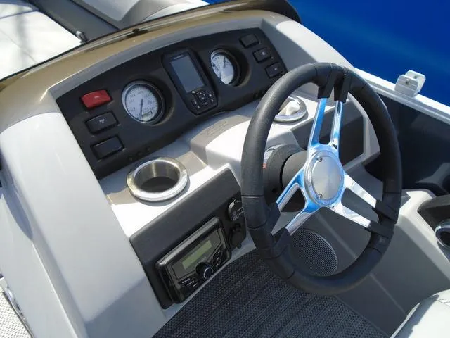 Slide: The Image of 2024 Bennington 21 SXL boat dashboard with steering wheel and gauges. - 3