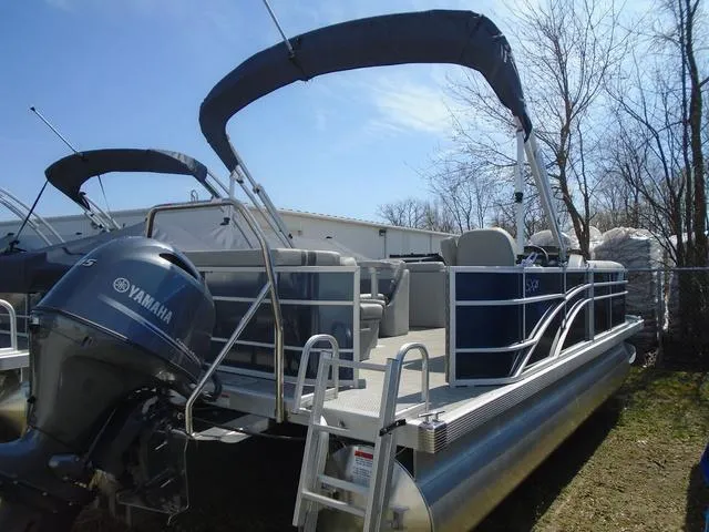 Slide: The Image of 2024 Bennington 21 SXL pontoon boat with Yamaha motor, docked outdoors. - 8