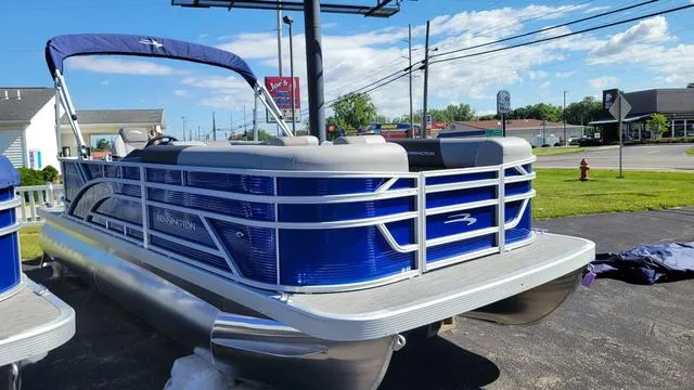 Slide: The Image of 2024 Bennington 20 SVL pontoon boat with blue exterior, parked outdoors on a sunny day. - 1
