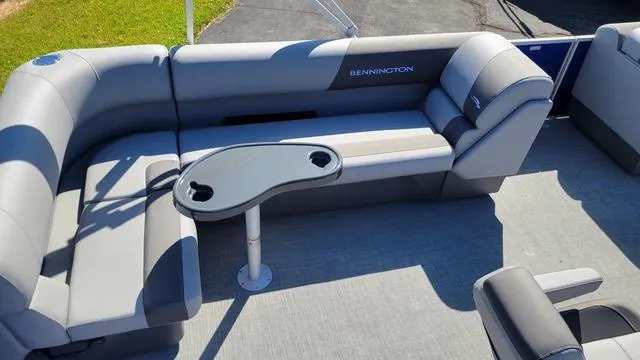 Slide: The Image of 2024 Bennington 20 SVL pontoon boat interior with gray seating and table. - 5