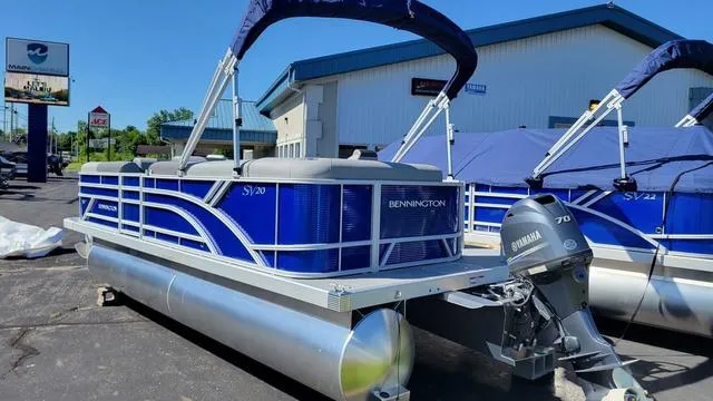 Slide: The Image of 2024 Bennington 20 SVL pontoon boat with Yamaha motor, displayed outdoors. - 8