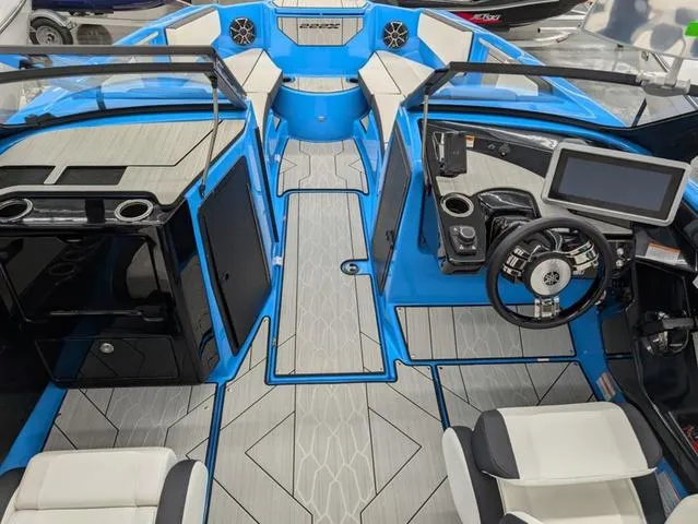 Slide: The Image of 2023 Yamaha Boats 222XD interior with modern dashboard, blue accents, and seating. - 4