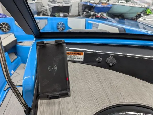 Slide: The Image of 2023 Yamaha Boats 222XD interior with wireless charging pad and modern dashboard features. - 7