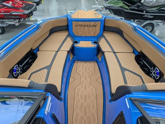 Slide: The Image of 2024 Yamaha Boats 255XD interior with tan seating and blue accents. - 10