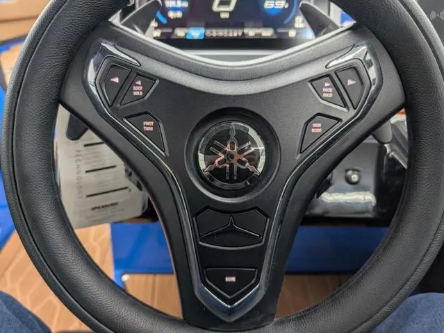 Slide: The Image of Steering wheel of 2024 Yamaha Boats 255XD with control buttons and digital display. - 11