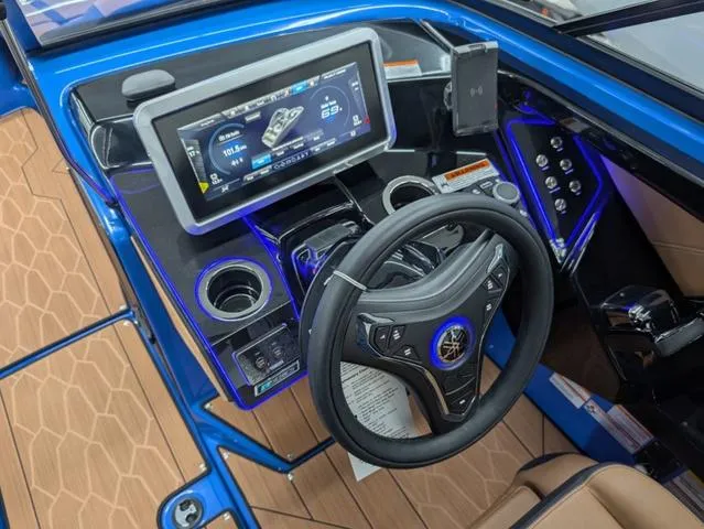 Slide: The Image of 2024 Yamaha Boats 255XD dashboard with touchscreen, steering wheel, and controls in a sleek design. - 12