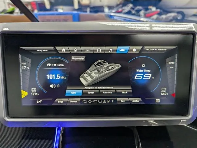 Slide: The Image of Dashboard display of 2024 Yamaha Boats 255XD showing FM radio and water temperature. - 13