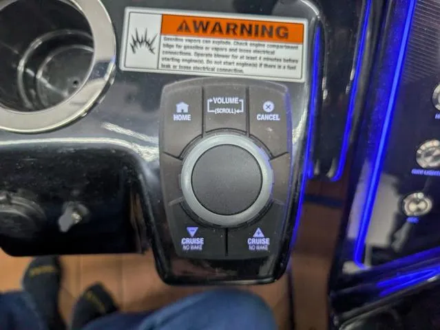 Slide: The Image of Control panel of 2024 Yamaha Boats 255XD with warning label and navigation buttons. - 14