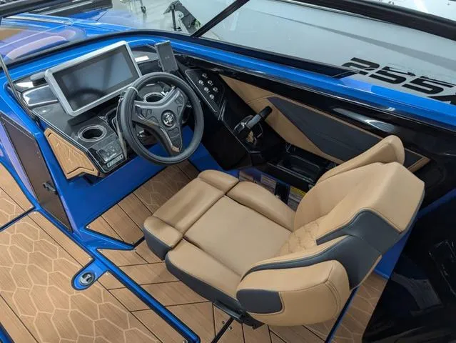 Slide: The Image of 2024 Yamaha Boats 255XD cockpit with modern dashboard and tan seating. - 8