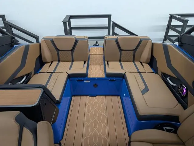Slide: The Image of 2024 Yamaha Boats 255XD interior with tan seating and blue accents. - 9