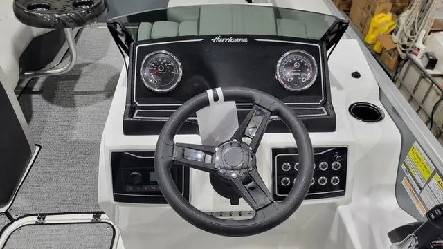 Slide: The Image of 2024 Hurricane FunDeck 2360 SBC OB dashboard with steering wheel and gauges. - 4