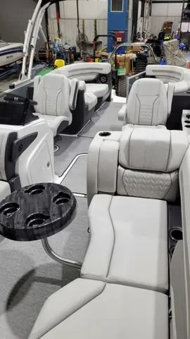 Slide: The Image of 2024 Hurricane FunDeck 2360 SBC OB interior with plush seating and cup holders. - 7