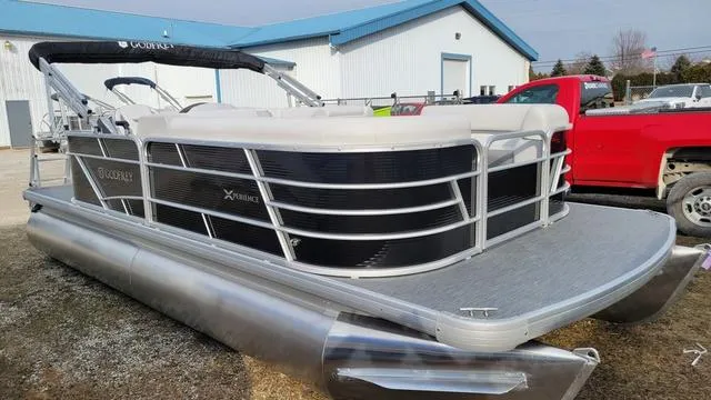 Slide: The Image of 2024 Godfrey Pontoons Xperience 2086 CX, silver pontoon boat, parked outdoors near a building. - 4