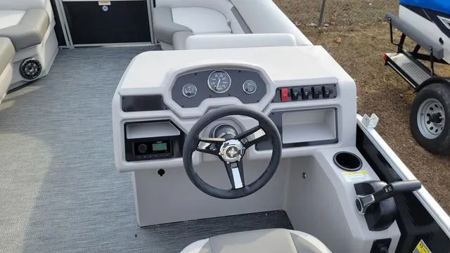 Slide: The Image of 2024 Godfrey Pontoons Xperience 2086 CX dashboard with steering wheel and controls. - 6