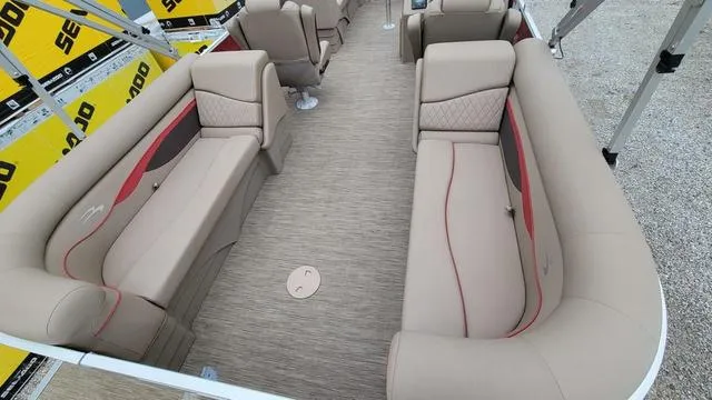 Slide: The Image of 2023 Bennington 22 SSR boat interior with beige seating and red accents. - 10