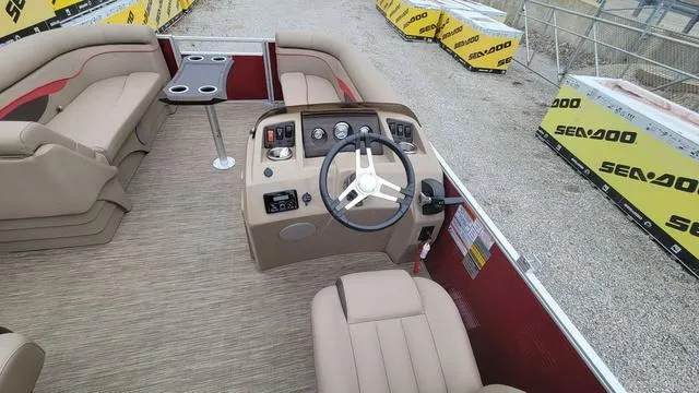 Slide: The Image of 2023 Bennington 22 SSR boat interior with steering wheel and seating, surrounded by Sea-Doo packaging. - 12
