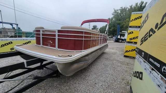 Slide: The Image of 2023 Bennington 22 SSR pontoon boat on trailer, surrounded by Sea-Doo boxes. - 14