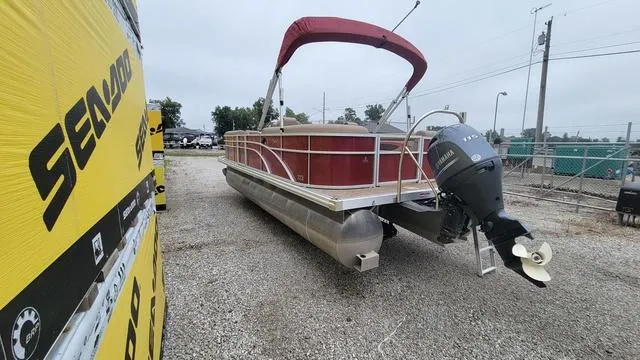 Slide: The Image of 2023 Bennington 22 SSR pontoon boat with red canopy and Yamaha outboard motor. - 15