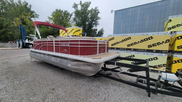 Slide: The Image of 2023 Bennington 22 SSR pontoon boat with red exterior on a trailer. - 3