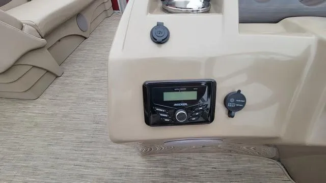 Slide: The Image of 2023 Bennington 22 SSR boat dashboard with radio and power outlets. - 7