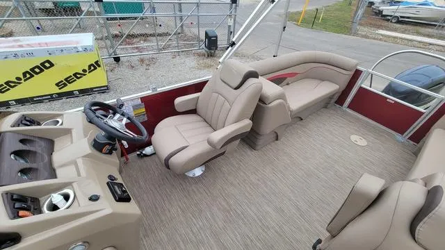 Slide: The Image of 2023 Bennington 22 SSR pontoon boat interior with beige seating and steering console. - 8
