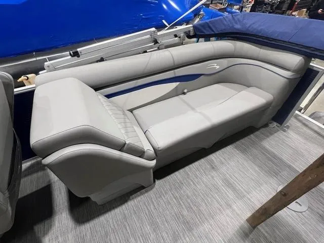 Slide: The Image of 2023 Bennington 22 SSR boat interior with gray seating and blue accents. - 11