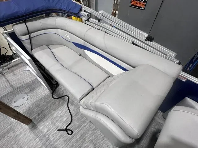 Slide: The Image of 2023 Bennington 22 SSR boat interior with gray seating and blue accents. - 12