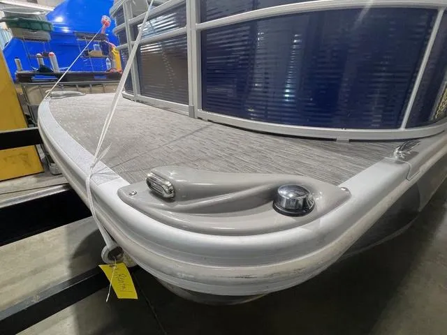 Slide: The Image of 2023 Bennington 22 SSR pontoon boat, docked indoors, showcasing sleek design and modern features. - 16