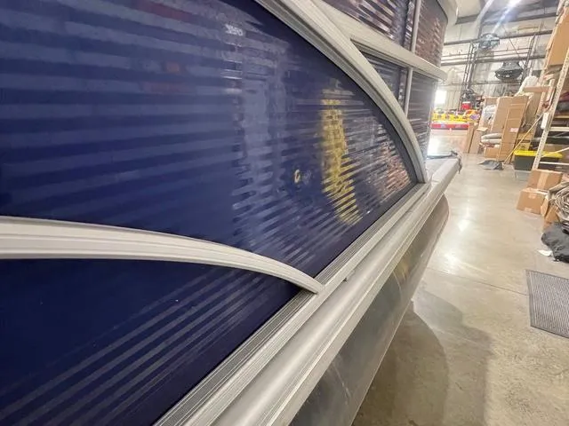 Slide: The Image of 2023 Bennington 22 SSR pontoon boat in a warehouse setting. - 18